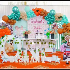 For Dishant's 'Wild One' party, I created a full safari scene with life-sized giraffe and lion props, a jeep cutout for photos, and a large light-up 'ONE'. The teal and orange balloon arch adds a unique and modern color twist to the classic jungle theme.
