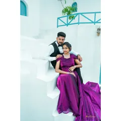 Elegance and romance captured on the steps of a beautiful white villa. The bride's flowing purple gown drapes gracefully, creating a sophisticated and timeless pre-wedding portrait.