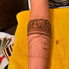 A before-and-after look at an elephant motif, showing the initial outline and the final filled-in design.