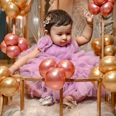 The little wave says it all. These are the candid, unposed moments that truly capture the personality of your child during their milestone celebration.