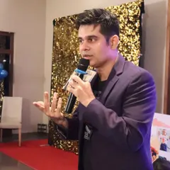 A candid shot of me in action, speaking to the audience. My goal is always to connect, engage, and entertain.