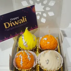 These are my sweet Mithai Candles, a truly unique gift for Diwali. This set includes candles shaped like a modak, motichoor ladoo, and peda, all beautifully packaged and ready to light up the festive season.