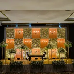 This engagement and reception stage combines floral panels with inset chandeliers for a warm, classic look. The design provides beautiful, soft lighting and a sense of timeless elegance.
