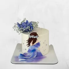 A delicate and artistic maternity cake celebrating the beauty of motherhood. The design features a hand-painted figure and soft floral touches.