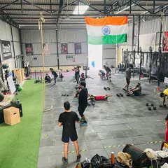 A wide view of a typical class in session. You can see different people working on various exercises, creating a dynamic and motivating environment for everyone.