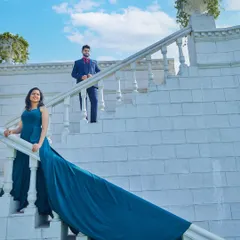 We use our wardrobe of long-trail gowns to add drama and elegance to shots on our grand white staircase, creating a truly cinematic feel.
