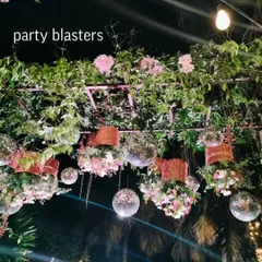 A unique wedding decor concept with hanging disco balls and floral baskets. This creates a fun, festive, and glamorous ceiling treatment for an outdoor reception.