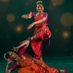 A dynamic moment from a duet performance at Medai Bengaluru. The interplay of poses and movements between two dancers creates a visual dialogue on stage.