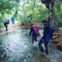 A team crossing a stream during our approach to City Falls. Knowing how to safely cross water is a fundamental trekking skill we practice on our trips.