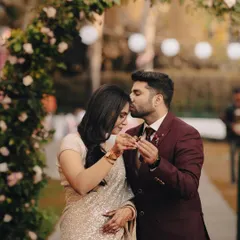A tender moment during the ring exchange, with the groom kissing the bride's forehead. This shot beautifully captures the love and promise of an engagement.