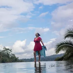 Capturing the feeling of freedom at the edge of an infinity pool in Ubud. I used the reflection in the water and the vast sky to create a sense of serenity and escape for this solo travel portrait.