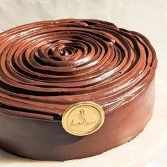 A close-up of our Belgian Dark Chocolate cake, showcasing the beautiful rose piping. This cake is for true chocolate lovers who appreciate a deep, authentic cocoa flavor.