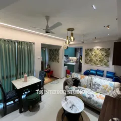 An overall view of a cozy living room layout. The design balances the seating area, dining space, and passage, making the room feel open and connected.