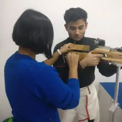 Our Junior Coach and National Shooter, Sapna Kumari, provides one-on-one guidance to a promising rifle shooter. This mentorship is crucial for developing competitive athletes.