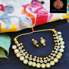For a modern take on traditional designs, I created this two-layer necklace inspired by the classic 'gini haar'. The mirrored terracotta coins are lightweight and catch the light beautifully, offering a chic and contemporary look. It is paired with simple, matching coin-style earrings.