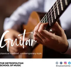 Our guitar lessons blend classical methods with contemporary styles. This close-up on the hands of a guitarist demonstrates the intricate fingerstyle technique taught in our classical guitar course.