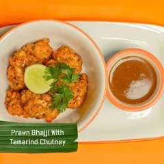 Prawn Bhajji with a tangy tamarind chutney. These crispy, savoury fritters are a perfect starter and a unique take on a classic snack.