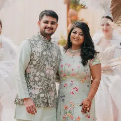 A classic portrait of the couple at their 'Farmer's Market' themed event. Their pastel outfits and the elegant decor create a soft and romantic image.