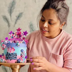 Hi, I'm Sarita, the baker and dreamer behind The Dessert Chowk. Here I am, putting the finishing touches on a K-Pop themed cake.
