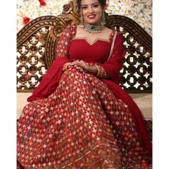 This vibrant red lehenga with intricate, all-over embroidery is a showstopper. It's a classic choice for bridal events or receptions, offering a rich, traditional look that is both timeless and elegant.