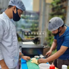 Our chefs meticulously preparing food outdoors. This behind-the-scenes shot shows the care and precision that goes into every dish we create.