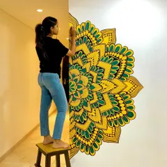 A half mandala painted directly onto the wall, creating a unique and beautiful feature in this home's hallway. The yellow and green colors bring so much life to the space.