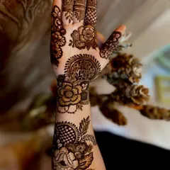 A beautiful example of a Dubai-style mehndi design. It combines elements of Arabic vines, Indian patterns, and geometric checkerboards for a full and intricate look that covers the entire hand and wrist.