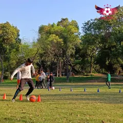 A player practices his dribbling technique through a cone drill. These exercises are fundamental for developing close ball control and confidence on the ball.