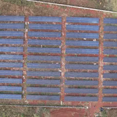 A top-down drone shot of the 1.3 MW solar farm, illustrating the precise layout and scale required for utility-grade power generation. Each row is optimized for maximum sun exposure and energy output.