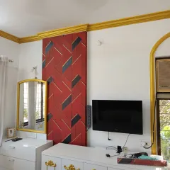 Don't be afraid to go bold. This installation features a striking red and black geometric wallpaper that acts as a powerful focal point in the bedroom. It’s a great example of how a dynamic pattern can energize a room and reflect a client's personality.