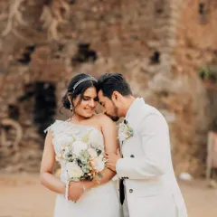 A tender moment captured against the rustic stone wall. Even in a formal, editorial shoot, I look for these instances of genuine affection.