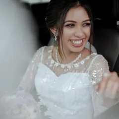 A candid shot of a Christian bride's joyful smile as she sits in the car, ready for her wedding.