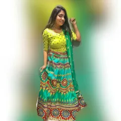 A bright and colorful printed lehenga perfect for a mehendi function or Navratri celebrations. The vibrant turquoise and lime green combination is fun and eye-catching.
