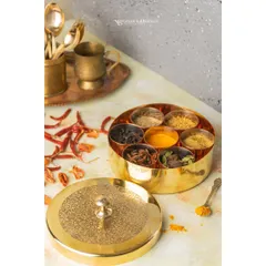 This photo showcases a brass spice box, giving it a premium, traditional feel. I used a light background to make the golden color of the brass stand out, and scattered whole spices around to add context and texture.