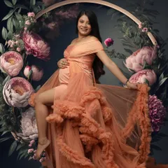 Surrounded by a halo of blooming peonies, this portrait in a peach ruffled gown is pure art. It captures a moment of joyful serenity and the beauty of a life in bloom.