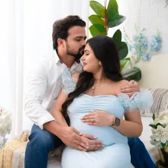 A tender forehead kiss is a simple yet powerful expression of love and support. This close-up shot captures the deep affection between the partners during their maternity session.