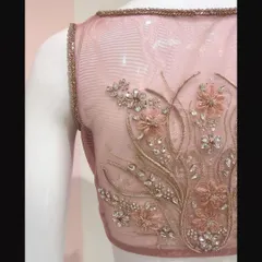 A crystal and organza flower embellished blouse we designed for a beautiful pastel Benarasi saree. The embroidery is done on a sheer net for a delicate look.