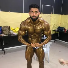 Front double biceps pose, backstage before hitting the stage. This is the condition I achieved to win the silver medal, a result of my uncle Kitty Murthy's guidance.
