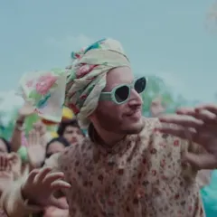 A fun moment from the baraat scene, where I styled one of the guests in a printed kurta with a floral safa and cool sunglasses for a modern festive look.