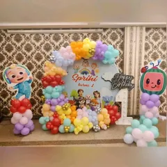 A vibrant Cocomelon first birthday setup for Sprihi. We used a custom backdrop featuring all the main characters and a colorful arrangement of balloons to create a fun and cheerful party atmosphere.