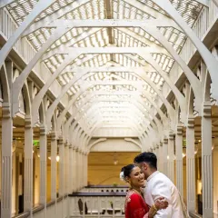 Using the stunning architecture of the venue to create a grand, editorial-style portrait. The leading lines of the corridor draw all the attention to the couple's embrace.