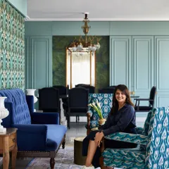 In the Bhanushali family residence, the living room is an oasis of color. Inspired by the sea, I used a striking Art Deco wallpaper and rich blue velvets to create a vibrant yet calming space for family gatherings, recycling a cherished mirror from their previous home.