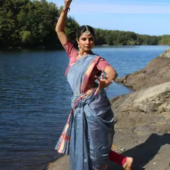 A dynamic shot from the @suta_bombay Navratri project, showcasing a strong dance pose against the backdrop of water and trees.