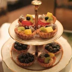 A classic two-tiered stand with fresh fruit tarts, perfect for a high tea or dessert spread at a home party. Our patisserie team creates beautiful and delicious treats for any occasion.