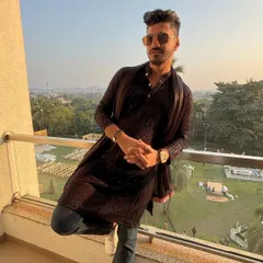 Taking a moment to chill on the balcony before a wedding gig in Daman. Dressed in a modern kurta, enjoying the view before the party begins.