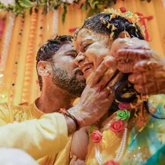 A moment of pure affection amidst the fun of the Haldi. We love capturing these spontaneous kisses and happy smiles as the couple gets covered in turmeric and love by their families.