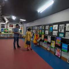 Visitors admiring the extensive collection of student art. Our exhibition provides a platform for students to share their work with a wider audience, building their confidence as artists.