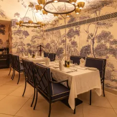 Our indoor dining area is set for an evening of refined taste. The elegant blue and white decor, inspired by Mediterranean aesthetics, provides a sophisticated backdrop for your meal.