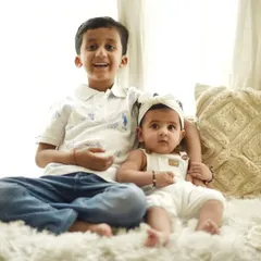 A bright and happy portrait of a big brother with his baby sister. The soft, high-key lighting and their relaxed poses create a feeling of warmth and affection. Capturing sibling bonds is one of my favorite things to do.