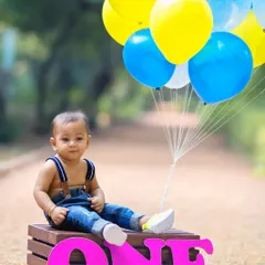 Balloons always add a pop of celebration. I use props like these to create a festive and vibrant atmosphere for first birthday portraits.